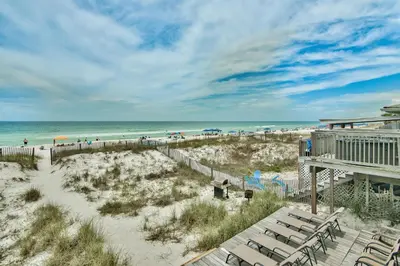 a view of a beach with chairs and the ocean at Beachcomber - Beachfront With Pool And Hot Tub - On The Beach! in Panama City Beach