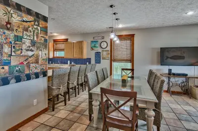 a dining room with a table and chairs at Beachcomber - Beachfront With Pool And Hot Tub - On The Beach! in Panama City Beach