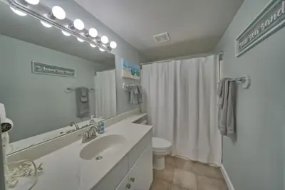 a bathroom with a sink and a toilet and a shower at Deluxe Beachfront Studio, Shores of Panama, Oceanviews and Updated in Panama City Beach
