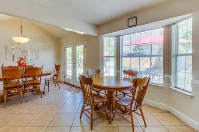 a kitchen and dining room with a table and chairs at Gulf View Home - Private Pool! in Panama City Beach