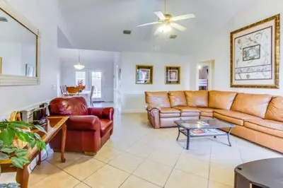a living room with a couch and a table at Gulf View Home - Private Pool! in Panama City Beach