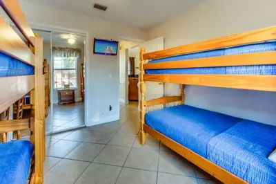 a bedroom with two bunk beds and a hallway at Gulf View Home - Private Pool! in Panama City Beach