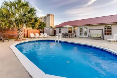 a large blue swimming pool in a yard at Gulf View Home - Private Pool! in Panama City Beach
