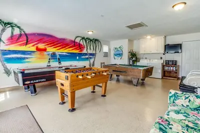 a living room with two pool tables and a mural at Gulf View Home - Private Pool! in Panama City Beach