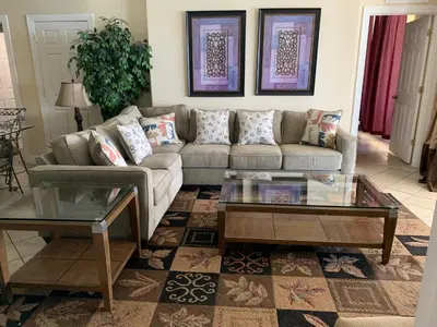 a living room with a couch and a coffee table at Tropic Winds Condo in Panama City Beach