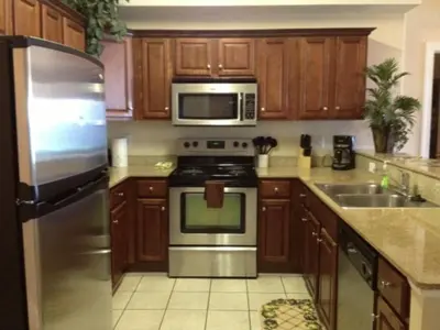 a kitchen with a stainless steel stove and a microwave at Tropic Winds Condo in Panama City Beach