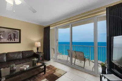 a living room with a couch and a view of the ocean at Boardwalk 1405 in Panama City Beach