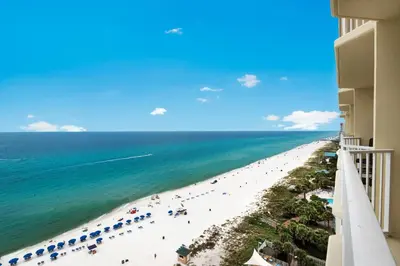 a view of the beach from the balcony of a resort at Boardwalk 1405 in Panama City Beach
