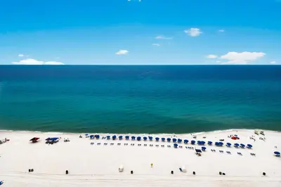 an aerial view of a beach with umbrellas and the ocean at Boardwalk 1405 in Panama City Beach