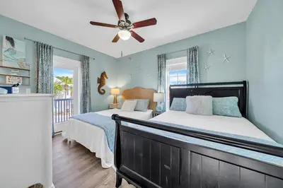 a bedroom with a bed and a ceiling fan at Four Fish Bungalow 155 in Santa Rosa Beach