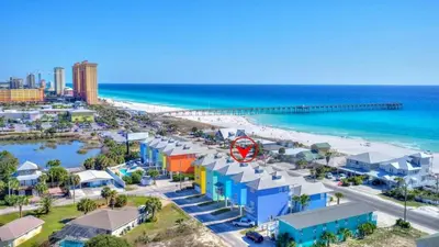an aerial view of a beach with buildings and the ocean at Sun Of A Beach - Beautiful Home Next To Pier Park - Swimming Pool! in Panama City Beach