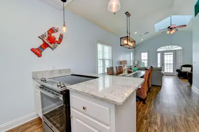 a kitchen with white walls and a counter top at Sun Of A Beach - Beautiful Home Next To Pier Park - Swimming Pool! in Panama City Beach