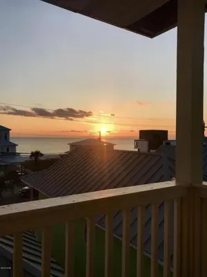 a view of the sunset from the balcony of a house at Sun Of A Beach - Beautiful Home Next To Pier Park - Swimming Pool! in Panama City Beach