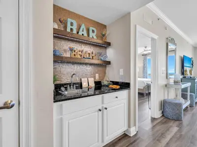 a kitchen with a sink and a brick wall at Calypso 2-1902 West in Panama City Beach