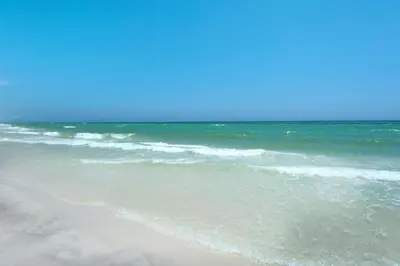 a sandy beach with the ocean in the background at Calypso 2-1902 West in Panama City Beach