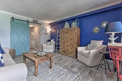 a living room with blue walls and a blue door at Pinnacle Port Getaway with Ocean View and Pool Access! in Panama City