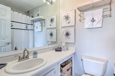 a bathroom with a sink and a toilet and a mirror at Pinnacle Port Getaway with Ocean View and Pool Access! in Panama City