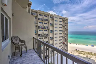 a balcony of a hotel with a chair and the beach at Pinnacle Port Getaway with Ocean View and Pool Access! in Panama City