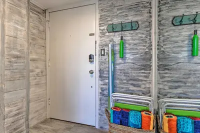 a bathroom with a stone wall and a door at Pinnacle Port Getaway with Ocean View and Pool Access! in Panama City