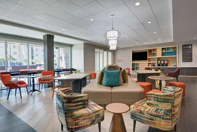a lobby with a couch and chairs and tables at Home2 Suites By Hilton Panama City Beach, Fl in Panama City Beach