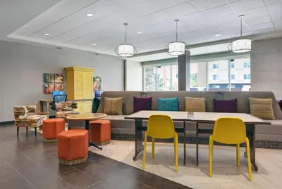 a waiting room with colorful chairs and a table at Home2 Suites By Hilton Panama City Beach, Fl in Panama City Beach