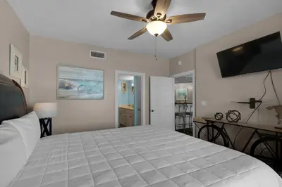a bedroom with a bed and a ceiling fan at Treasure Island 0205 in Panama City Beach