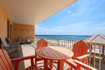 a balcony with a table and chairs and the ocean at Treasure Island 0205 in Panama City Beach