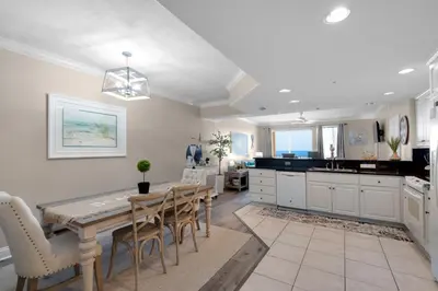 a kitchen and dining room with a table and chairs at Treasure Island 0205 in Panama City Beach