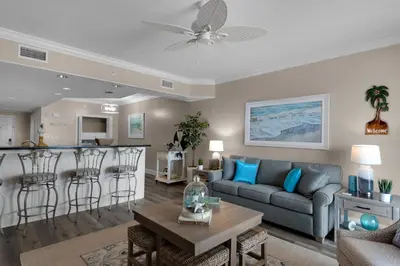 a living room with a couch and a table at Treasure Island 0205 in Panama City Beach