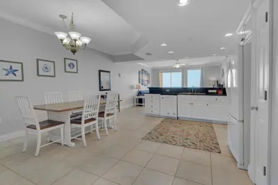 a kitchen and dining room with a table and chairs at Treasure Island 0207 in Panama City Beach