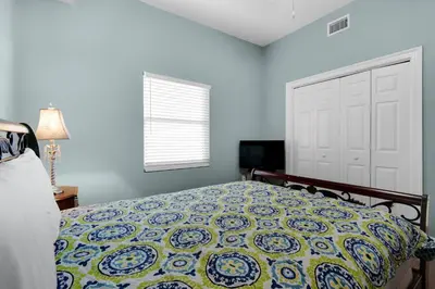 a bedroom with a bed and a white door at Treasure Island 0305 in Panama City Beach