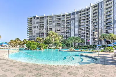 a swimming pool in front of a large building at Nautical Edgewater Resort Condo - Walk to Beaches! in Panama City Beach