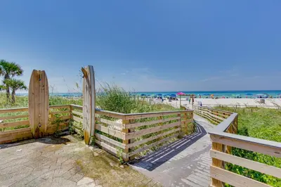 a wooden fence at the beach next to the beach at Nautical Edgewater Resort Condo - Walk to Beaches! in Panama City Beach