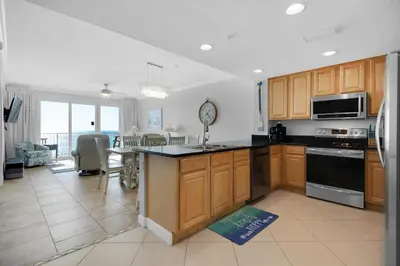 a kitchen with wooden cabinets and a counter top at Grandview East 304 in Panama City Beach