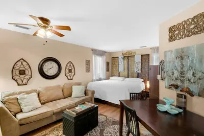 a living room with a couch and a bed at Sandcastle Villas #24 in Panama City Beach
