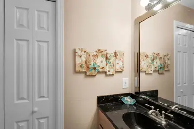 a bathroom with a sink and a mirror at Sandcastle Villas #24 in Panama City Beach
