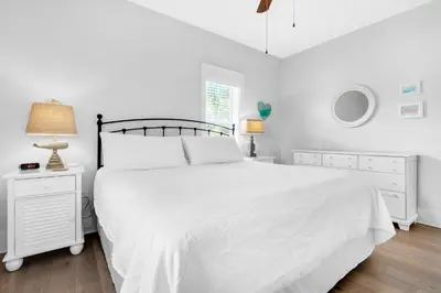 a white bedroom with a white bed and a window at Seagrove Bungalow 153 in Santa Rosa Beach