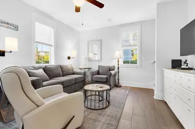 a living room with a couch and a tv at Seagrove Bungalow 153 in Santa Rosa Beach