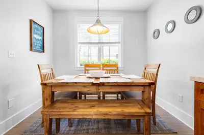 a dining room with a wooden table and chairs at Seagrove Bungalow 153 in Santa Rosa Beach