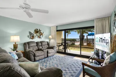 a living room with a couch and a table at Commodore 107 (2/2) in Panama City Beach