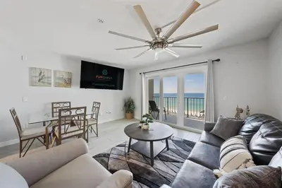 a living room with a couch and a table at The Summit 615 in Panama City Beach