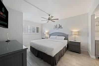a bedroom with a bed and a ceiling fan at The Summit 615 in Panama City Beach