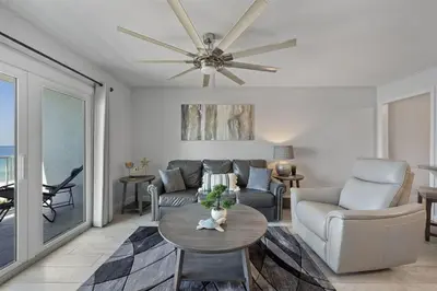 a living room with a couch and a ceiling fan at The Summit 615 in Panama City Beach