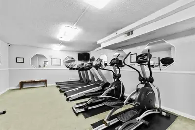 a gym with several cardio machines in a room at The Summit 1006 in Panama City Beach