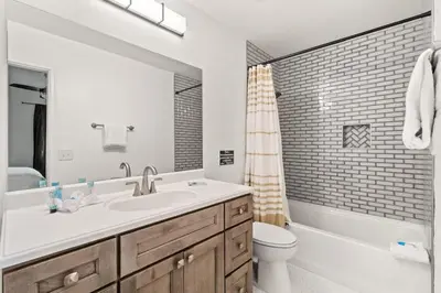 a bathroom with a sink and a toilet and a tub at 5218 Beach Dr A in Panama City Beach
