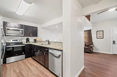 a kitchen with stainless steel appliances and wooden floors at 5218 Beach Dr A in Panama City Beach