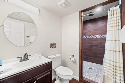 a bathroom with a toilet and a sink and a shower at 5218 Beach Dr A in Panama City Beach