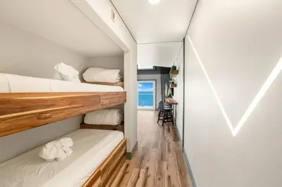 a small room with two bunk beds and a window at The Summit 1107 in Panama City Beach