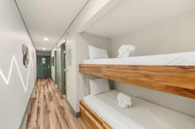 a room with two bunk beds and a hallway at The Summit 1107 in Panama City Beach