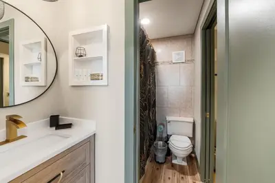 a bathroom with a toilet and a sink and a mirror at The Summit 1107 in Panama City Beach